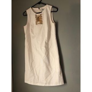 White mid-dress with gold pendant